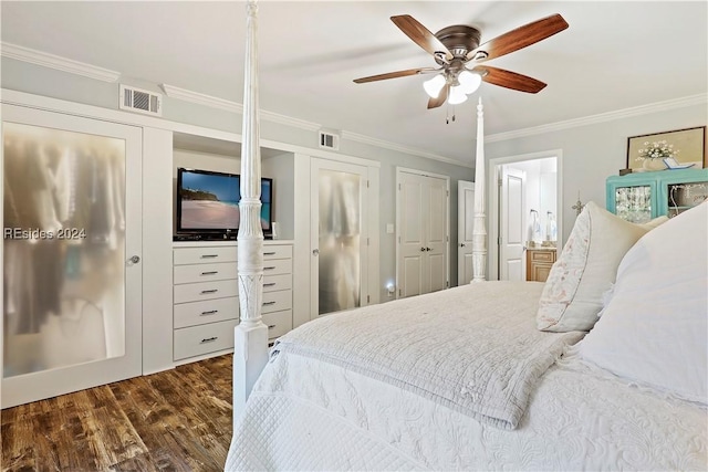 bedroom with crown molding, ceiling fan, multiple closets, and dark hardwood / wood-style floors