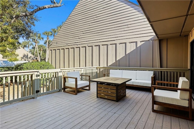 deck with an outdoor living space with a fire pit