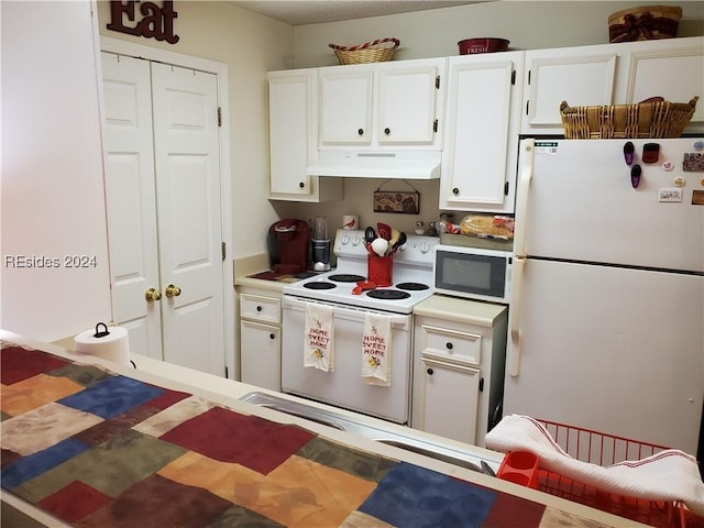 kitchen with white appliances and white cabinets