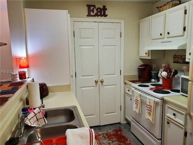 kitchen with white cabinetry and white electric stove