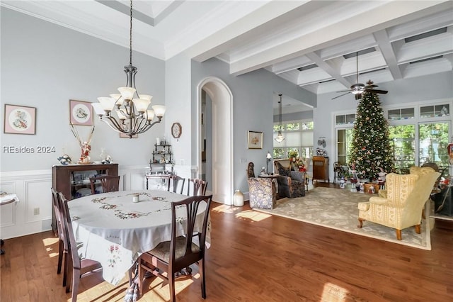 dining room with hardwood / wood-style flooring, coffered ceiling, ornamental molding, ceiling fan with notable chandelier, and beamed ceiling