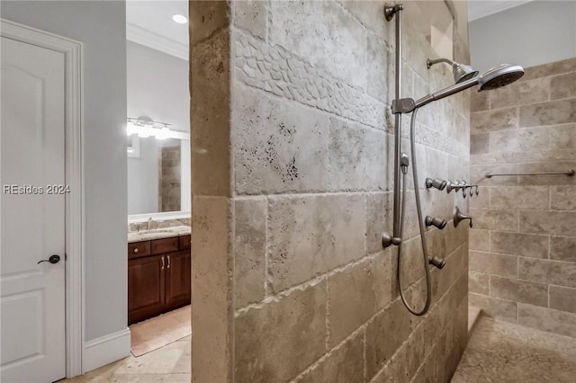 bathroom with crown molding, vanity, and a tile shower