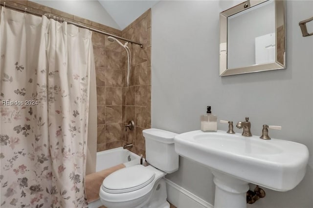 full bathroom featuring lofted ceiling, sink, shower / tub combo, and toilet