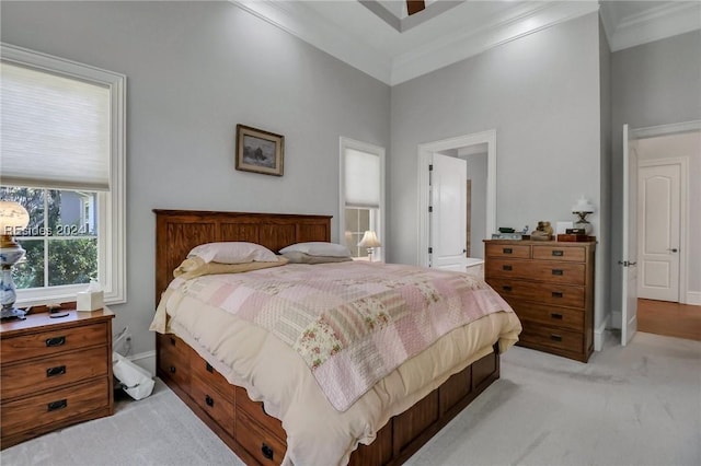 bedroom featuring crown molding, a towering ceiling, and light carpet