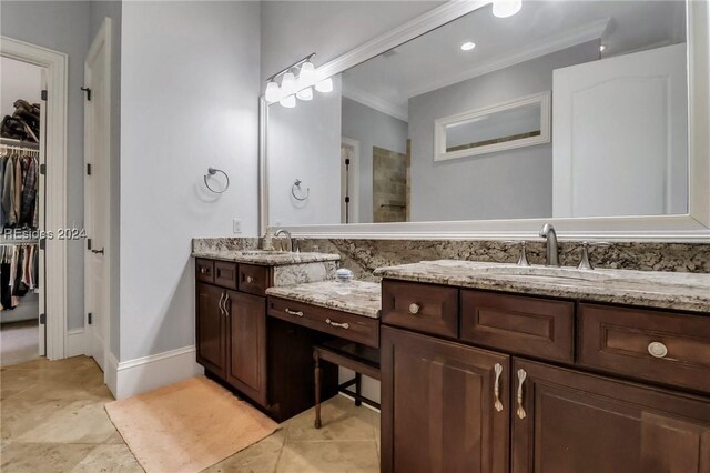 bathroom featuring crown molding and vanity