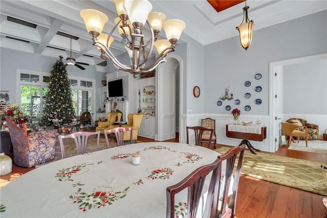 dining area featuring hardwood / wood-style floors, coffered ceiling, ceiling fan with notable chandelier, and beam ceiling