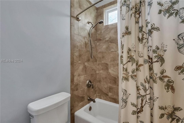 bathroom featuring shower / bathtub combination with curtain and toilet