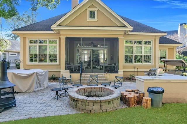 back of house with area for grilling, a sunroom, a patio, and a fire pit