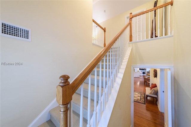 stairway with hardwood / wood-style floors