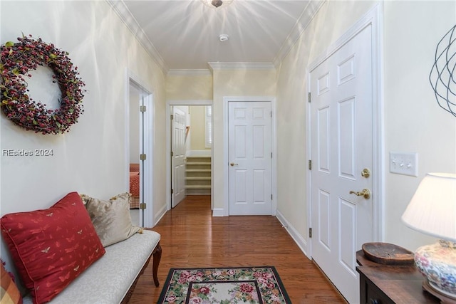 hall featuring ornamental molding and dark hardwood / wood-style floors