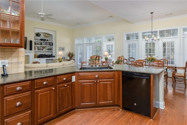 kitchen with a wealth of natural light, black dishwasher, sink, and decorative backsplash