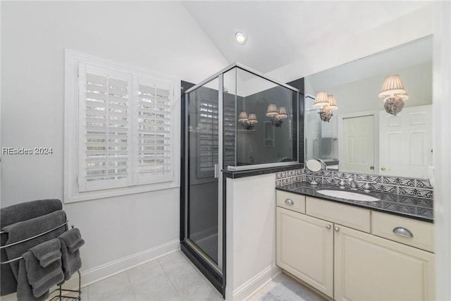 bathroom featuring vanity, tile patterned flooring, and a shower with shower door