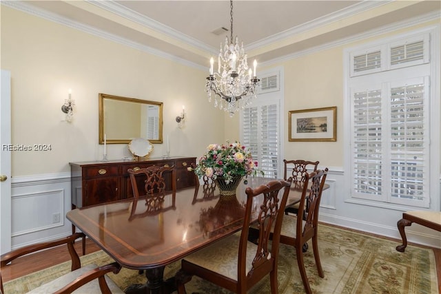 dining space featuring hardwood / wood-style floors, crown molding, and a healthy amount of sunlight