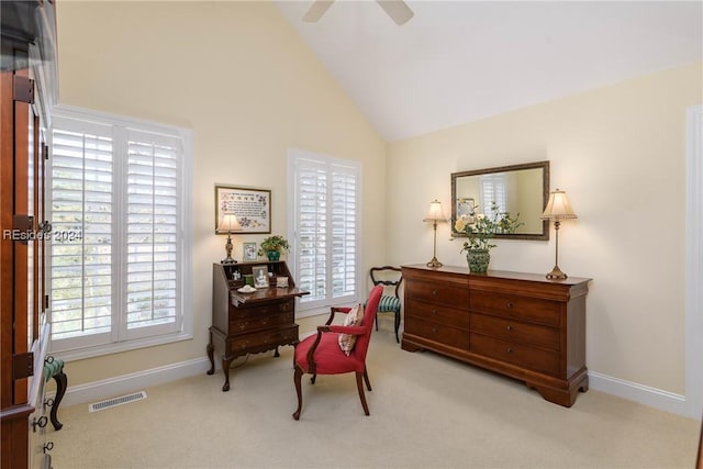 sitting room featuring light carpet, high vaulted ceiling, and ceiling fan