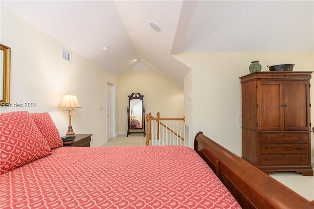 bedroom with light colored carpet and lofted ceiling