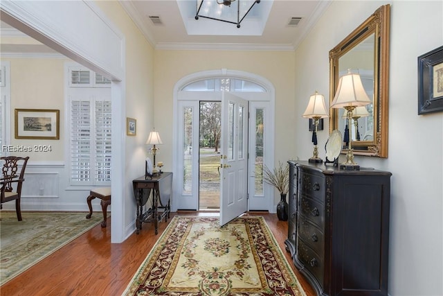 entryway featuring ornamental molding and hardwood / wood-style floors