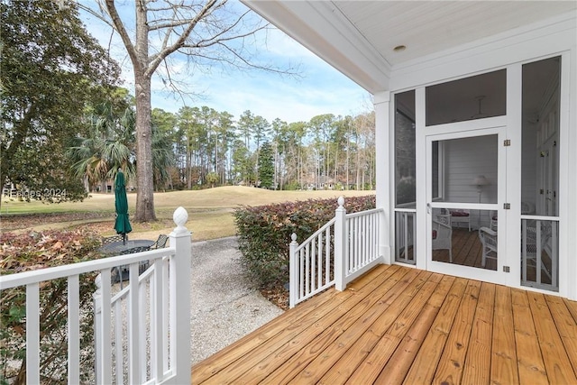 wooden terrace featuring a sunroom