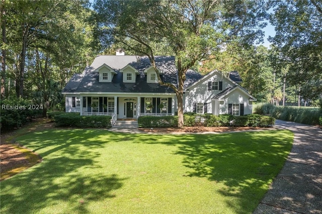 cape cod house with a porch and a front lawn