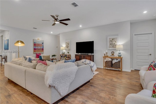 living room with ceiling fan and light wood-type flooring