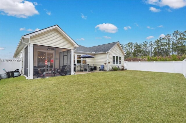 back of property featuring a patio, a sunroom, a yard, and ceiling fan