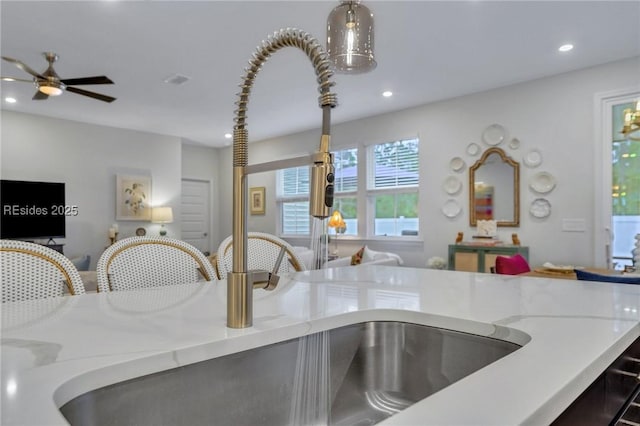 interior details featuring pendant lighting and light stone countertops