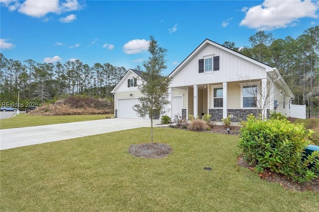 view of front of property with a garage, covered porch, and a front lawn