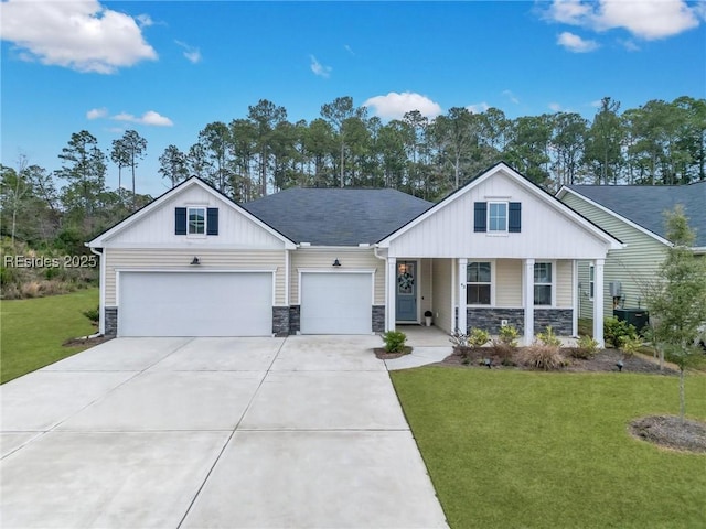 view of front of house featuring a garage, a front yard, and covered porch