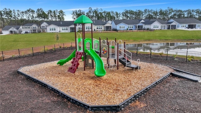 view of play area with a water view and a yard