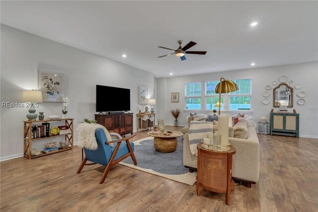 living room featuring ceiling fan and wood-type flooring