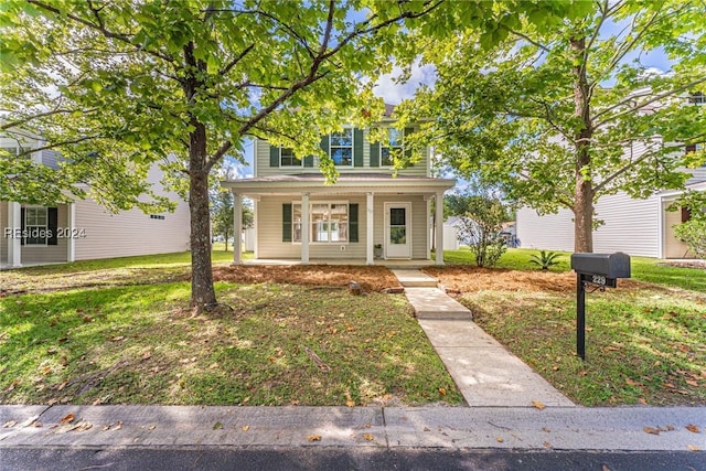 view of front facade featuring a front yard and covered porch