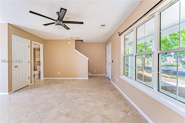 spare room featuring light tile patterned floors and ceiling fan