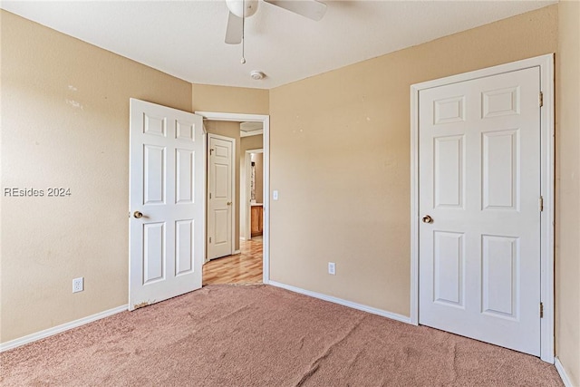 unfurnished bedroom with light carpet and ceiling fan