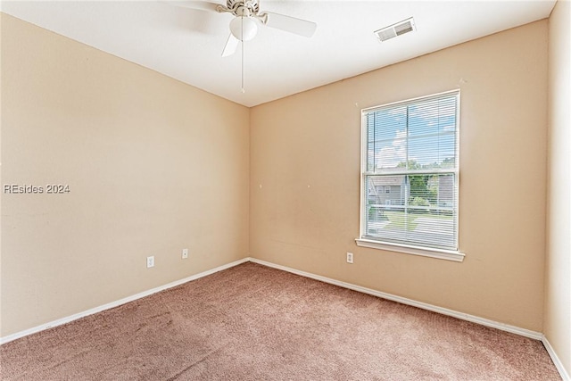 unfurnished room featuring ceiling fan and carpet floors