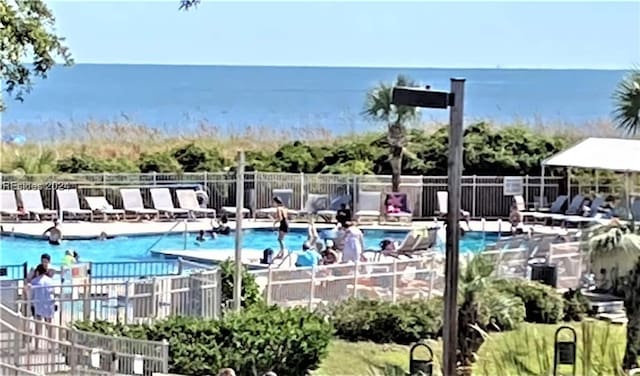 view of swimming pool with a water view