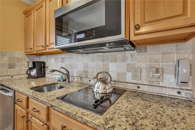 kitchen with tasteful backsplash, stainless steel appliances, light brown cabinetry, and sink