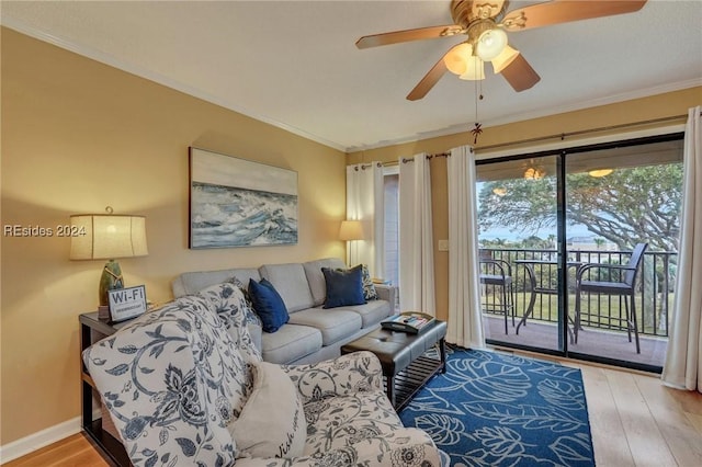 living room featuring crown molding, ceiling fan, and light hardwood / wood-style flooring