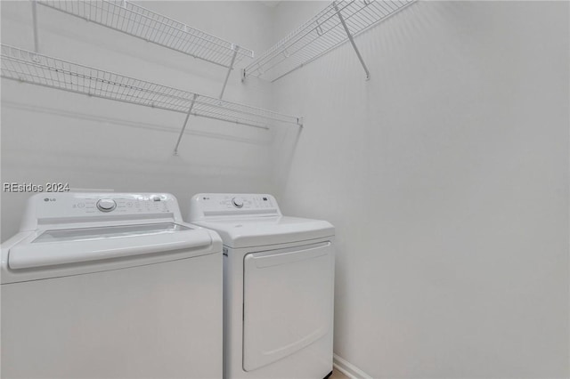 washroom featuring washer and clothes dryer