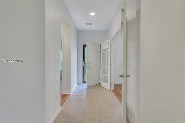 corridor featuring light tile patterned flooring