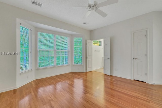 spare room featuring light hardwood / wood-style flooring and ceiling fan