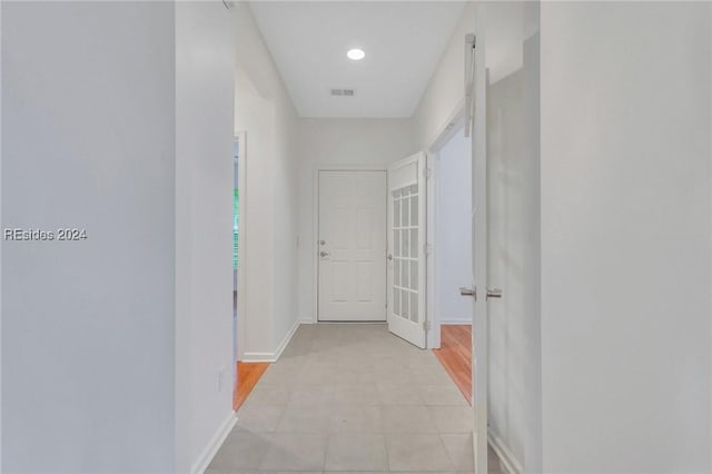 hall with light tile patterned flooring