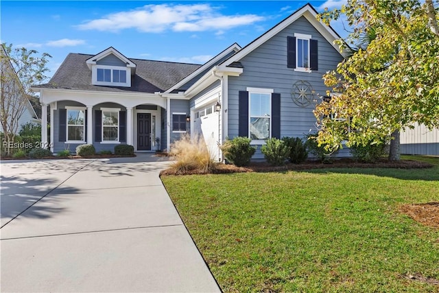 view of front of property featuring a garage and a front yard