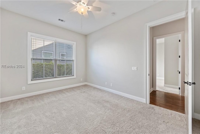 carpeted empty room featuring ceiling fan