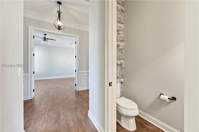 bathroom with ornamental molding, hardwood / wood-style floors, and toilet