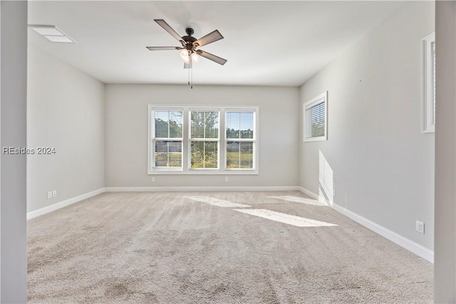 carpeted spare room with ceiling fan