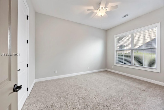 carpeted empty room featuring ceiling fan