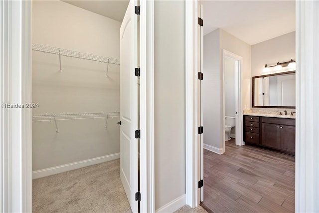 bathroom with vanity, toilet, and hardwood / wood-style floors