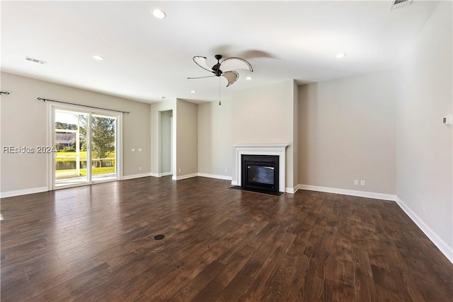 unfurnished living room featuring ceiling fan and dark hardwood / wood-style flooring