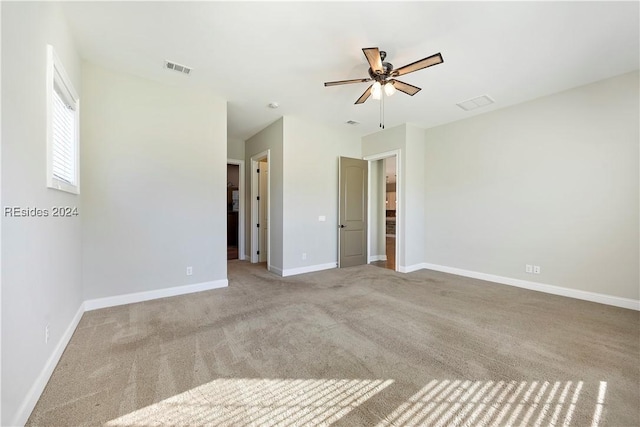 unfurnished room with ceiling fan and light carpet