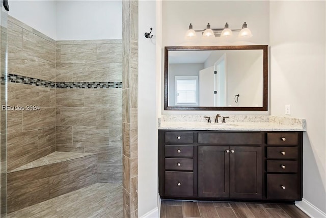 bathroom featuring vanity and tiled shower