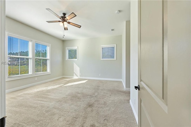 unfurnished room featuring ceiling fan and light carpet